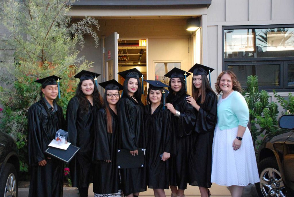 Eight women with graduation cap