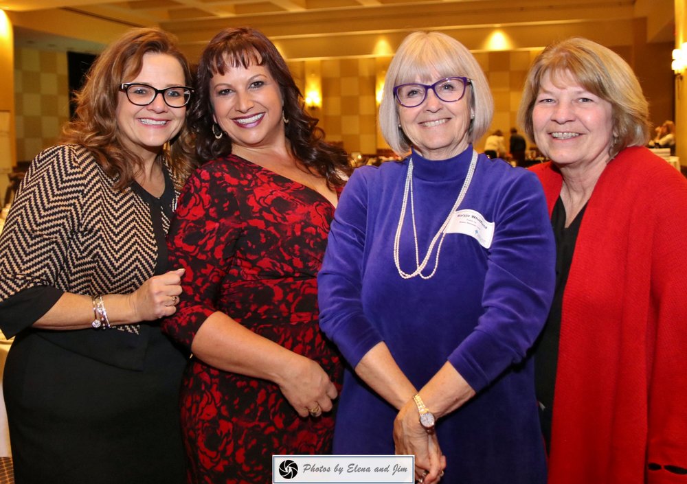 Four happy senior age women