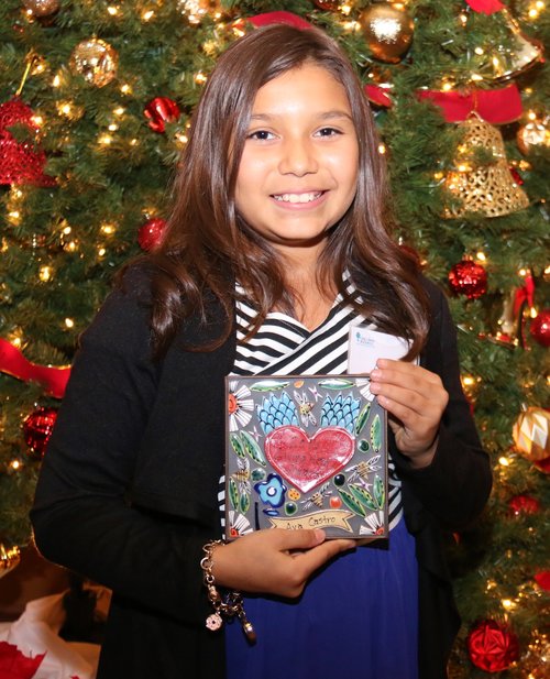 Little girl holding painting