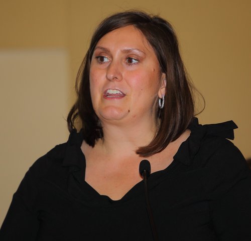 Women in black shirt speaking on mic