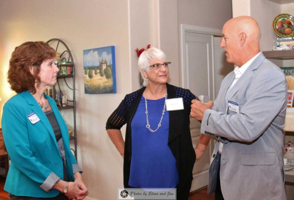 Three senior age people talking with each other