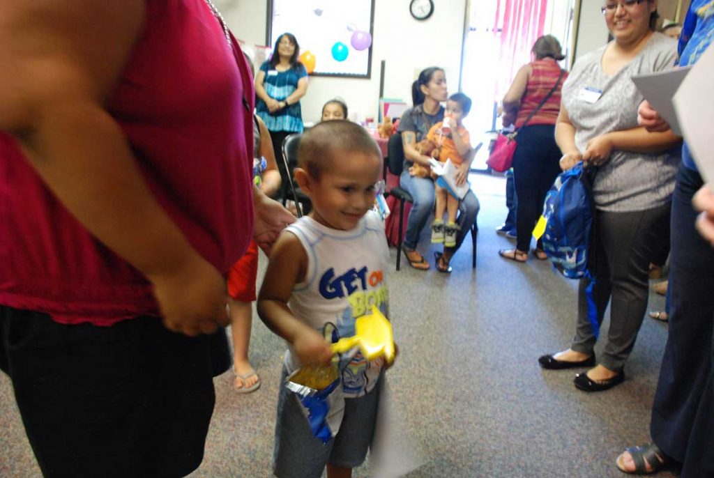 Little boy holding toys