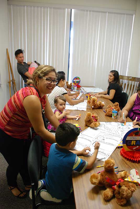 Teachers and students doing painting on table