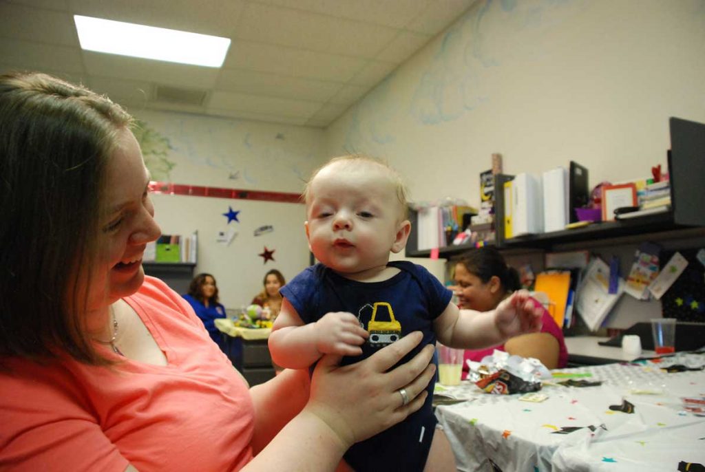 Women holding little boy