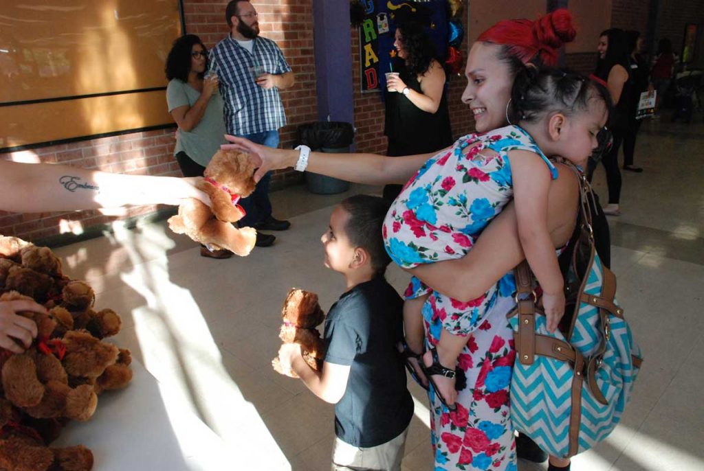 Women holding little daughter with her little son