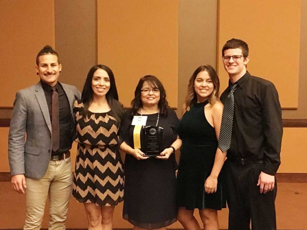 woman standing with award