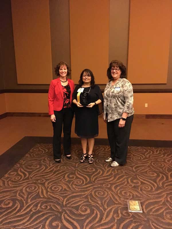 three woman receiving award