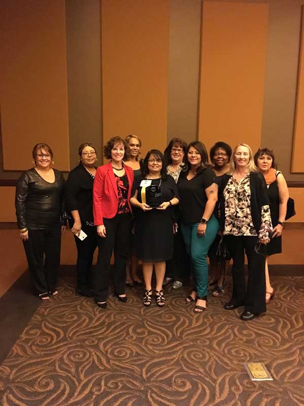 woman standing with award