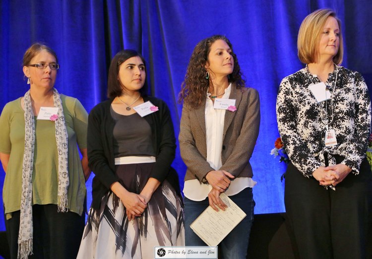 Four women standing on stage