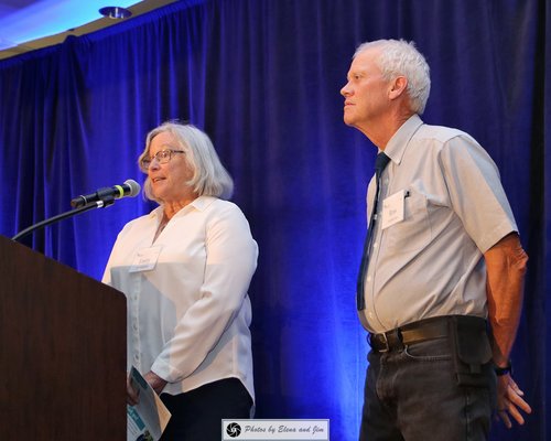 Two senior age man and women on a stage