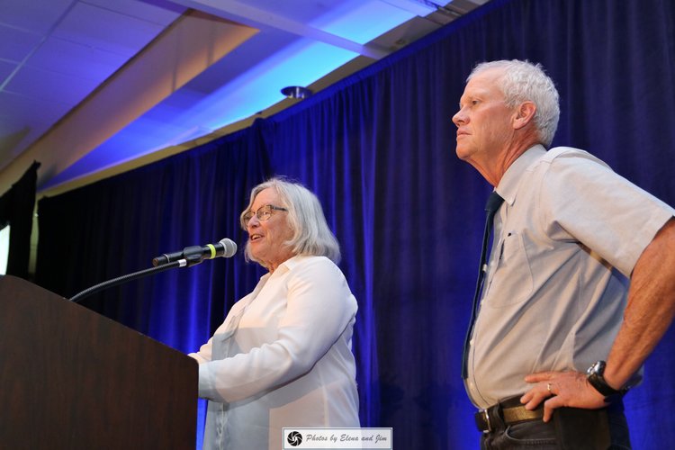 Two senior age man and women on a stage