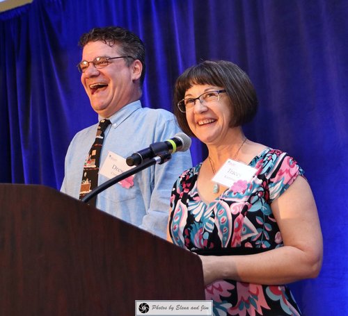 Man and women speaking on mic