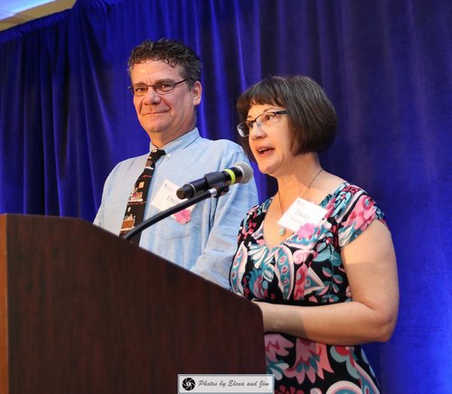 Man and women speaking on mic