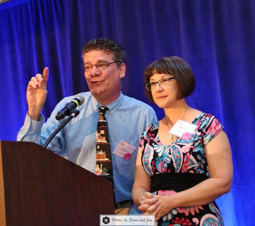 Man and women speaking on mic