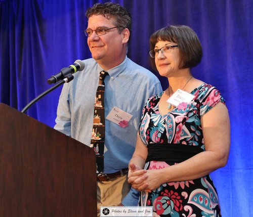 Man and women speaking on mic