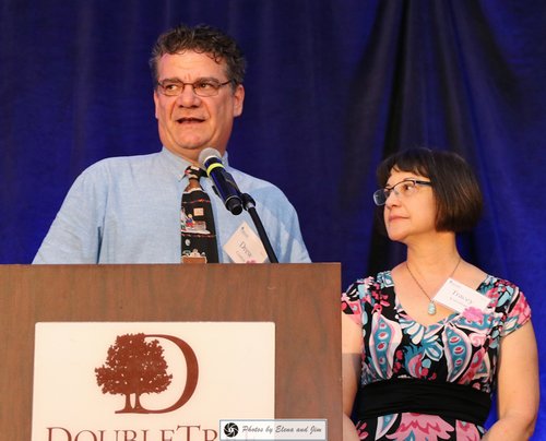 man and women speaking on mic