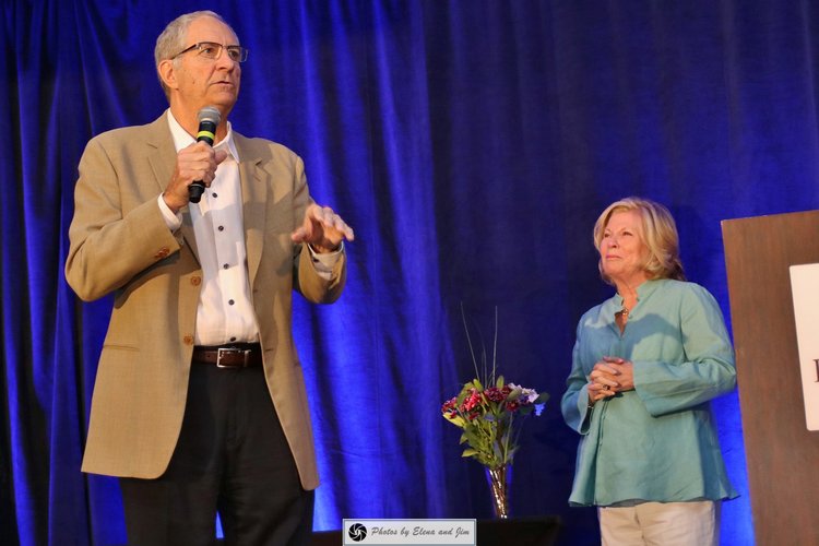 man and women speaking on stage