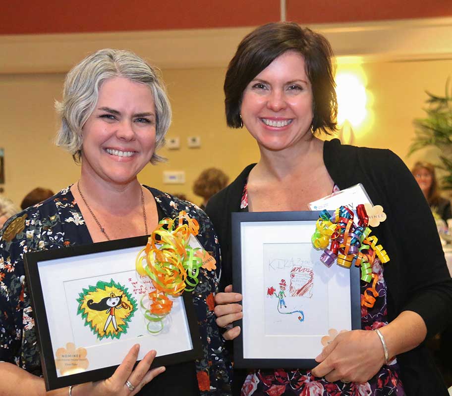 Two happy women with painting