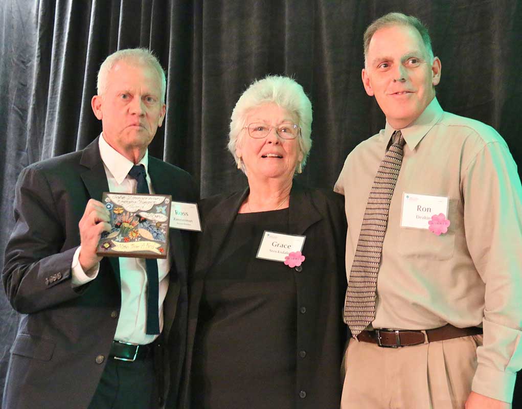 Three senior age people on stage