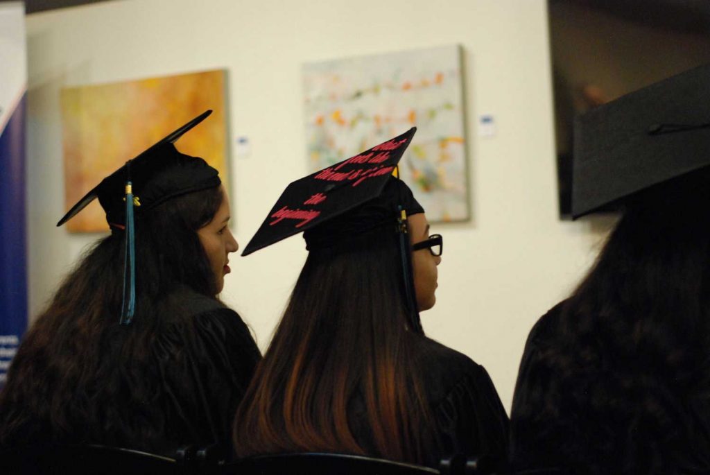 Two women wearing graduation cap