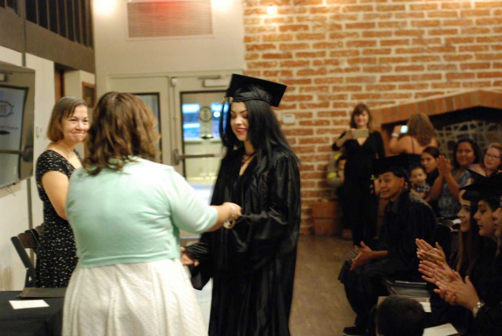 Women giving certificate to student