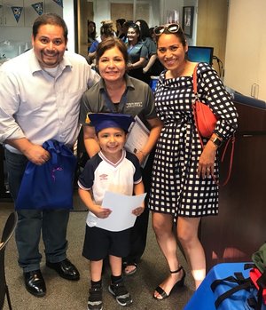 Parents and Teacher with Little boy certification success