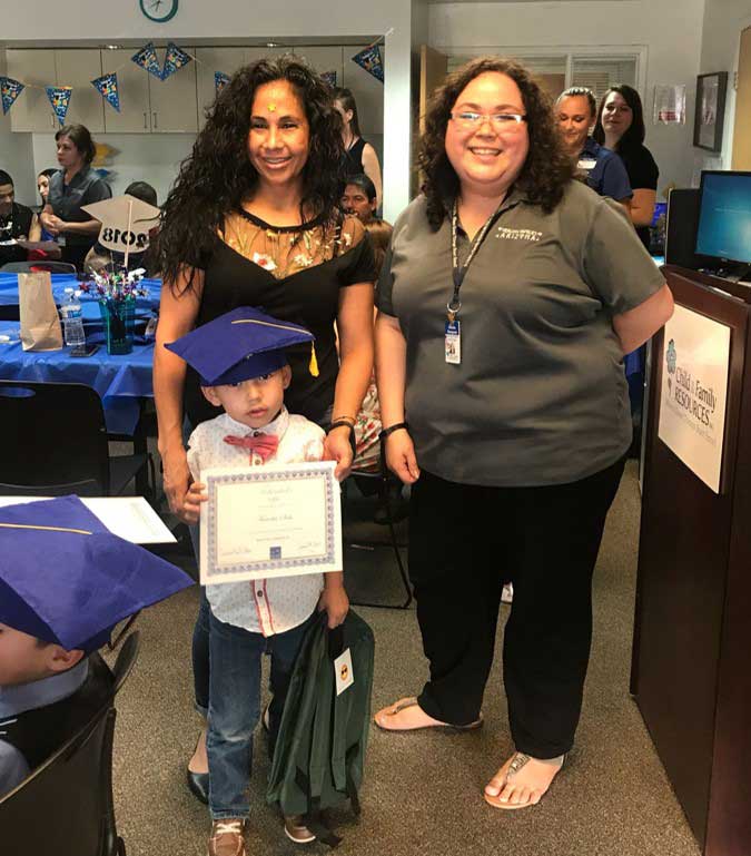 Team member with Mother and children