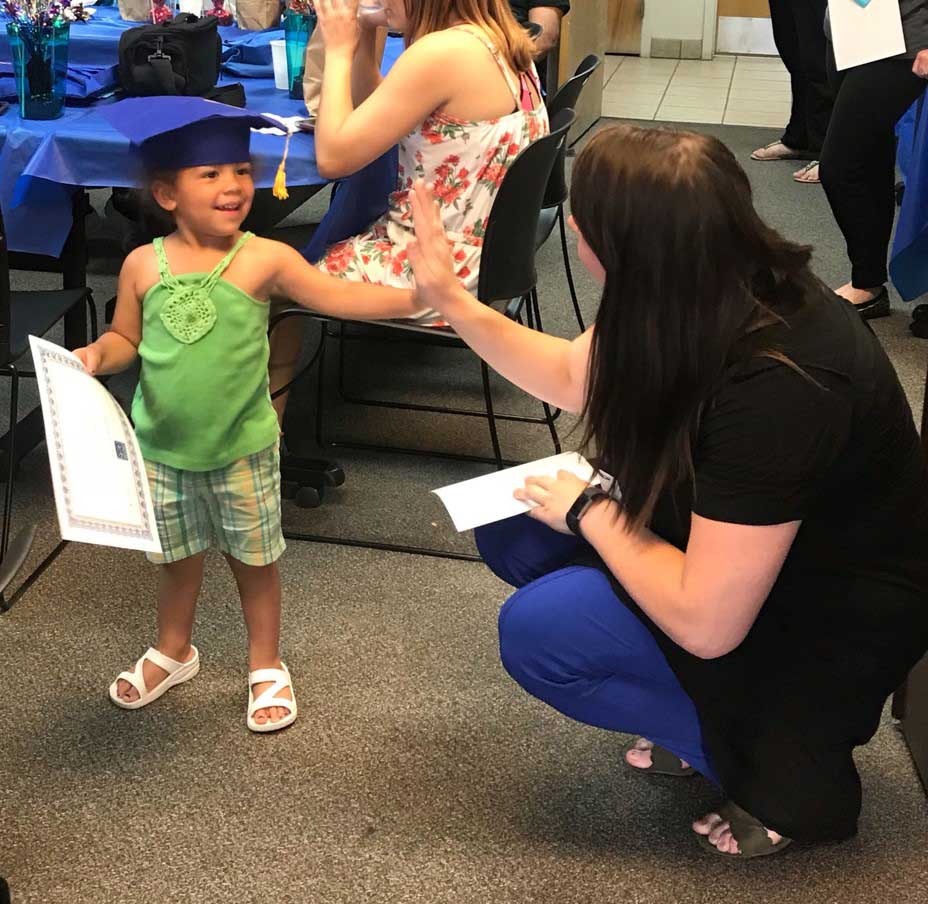 Mother and daughter giving high five to each other