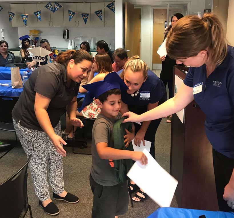 Team member giving bag to little boy