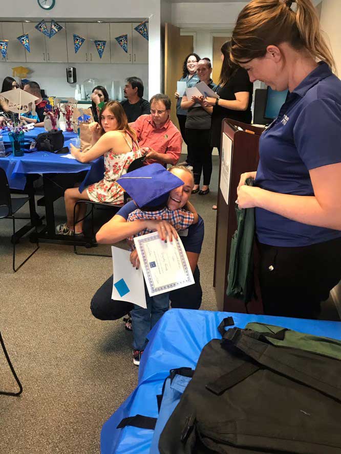 Team member giving hug to little son