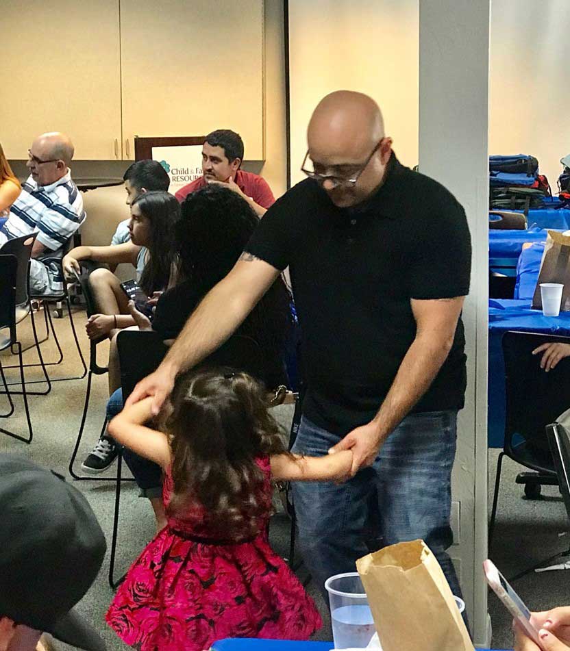 Father and little daughter dancing