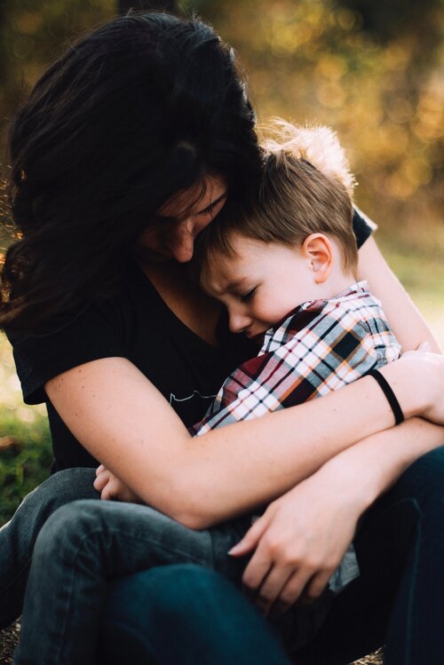 Mother comforting crying son