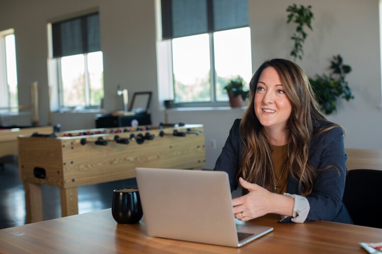 Woman having conversation while using laptop