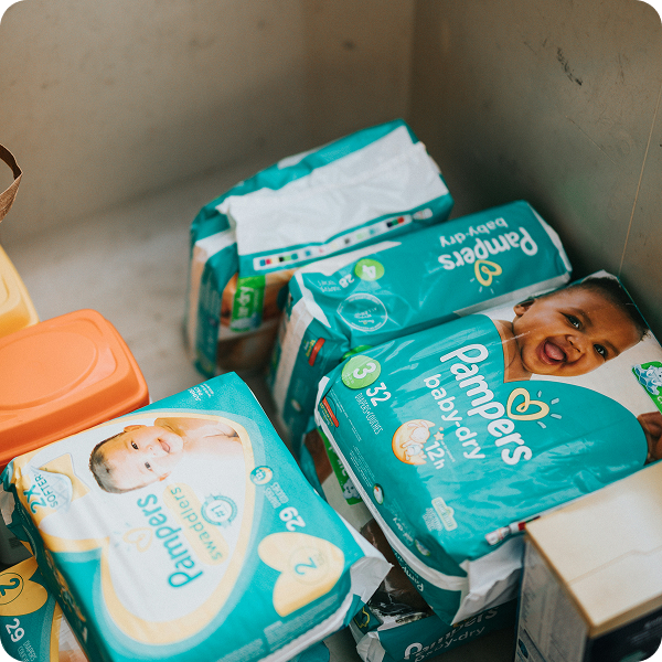 Stacks of Pampers diapers in a storage bin