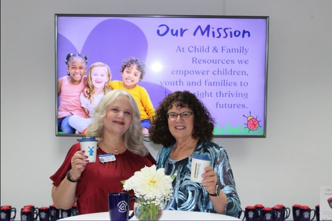 Two staff at Child & Family Resources outreach table