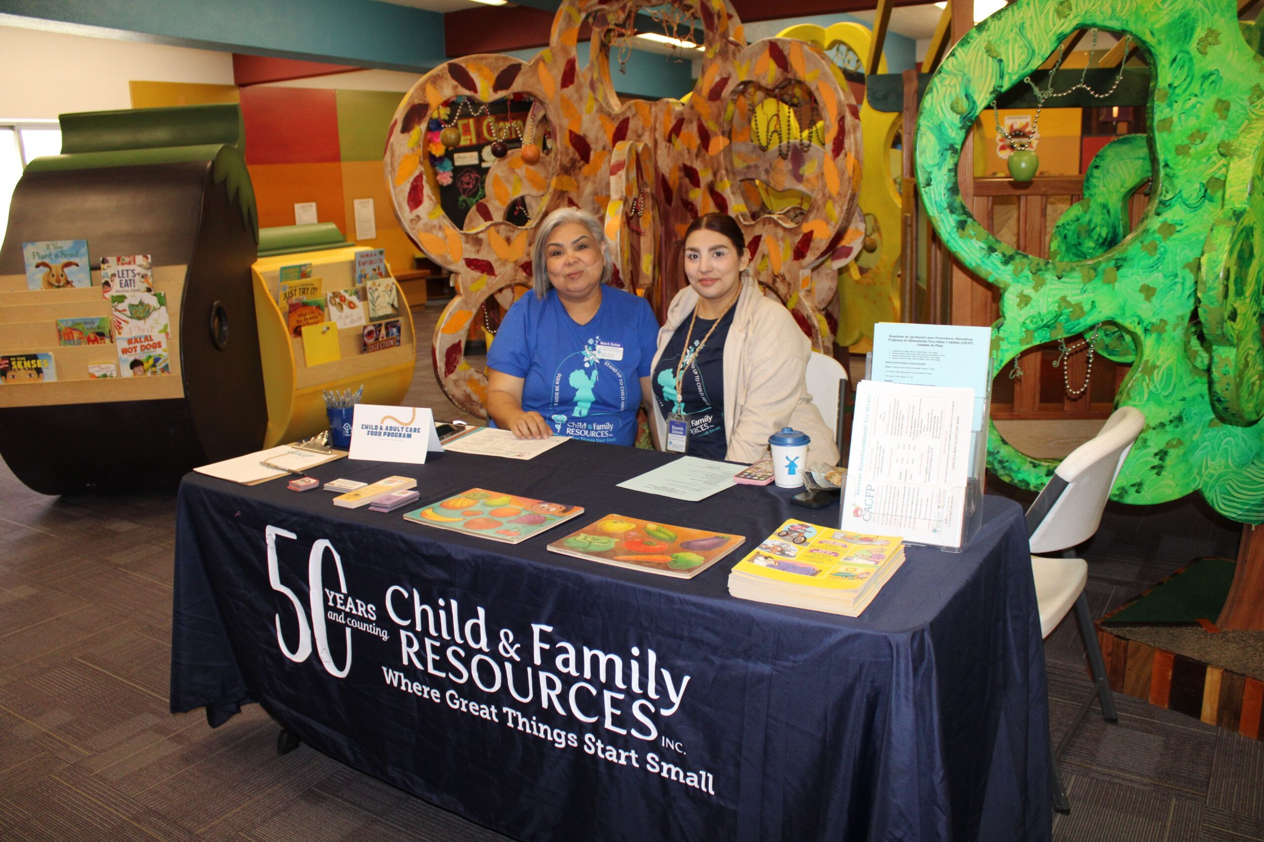 Two staff at Child & Family Resources outreach table