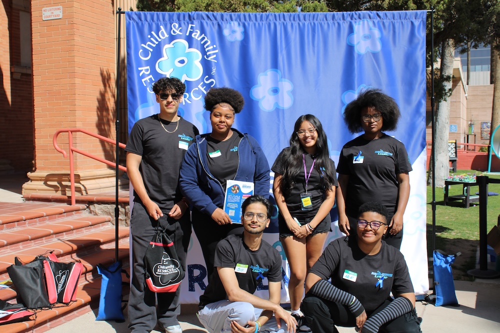 Six youth leaders against blue floral backdrop