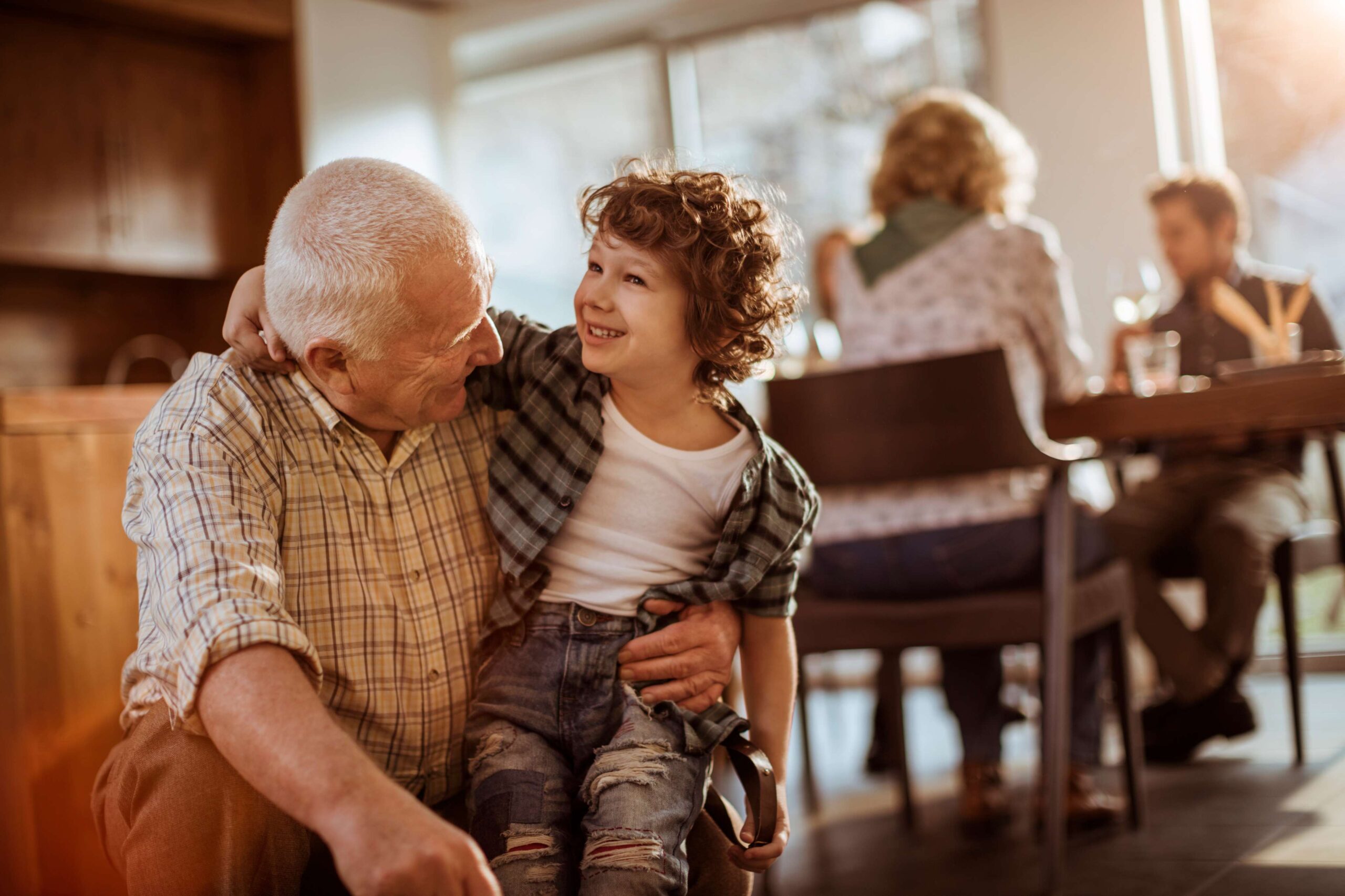 Grandfather holding smiling young boy